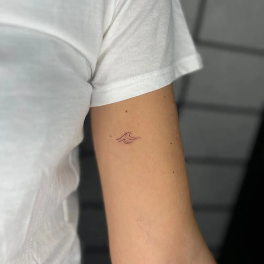 Tiny Minimalist Wave Tattoo on Women Arm by @thewalkinby1928