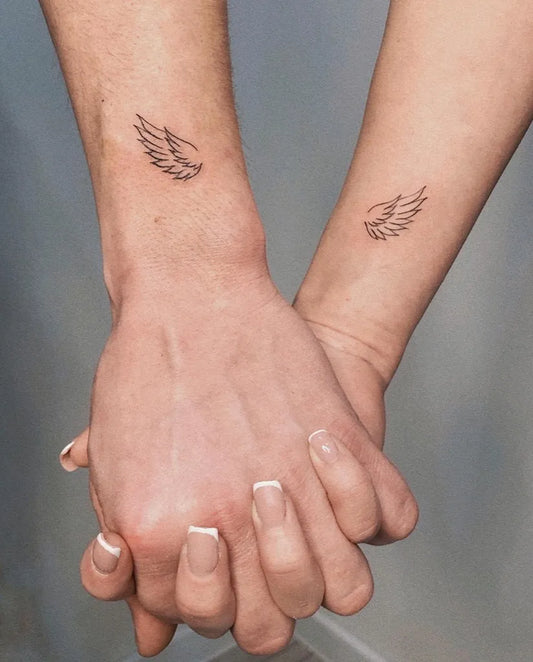 Tiny Minimalist Wing on Couple Wrist Matching Tattoo by @lovedots_ttattoo