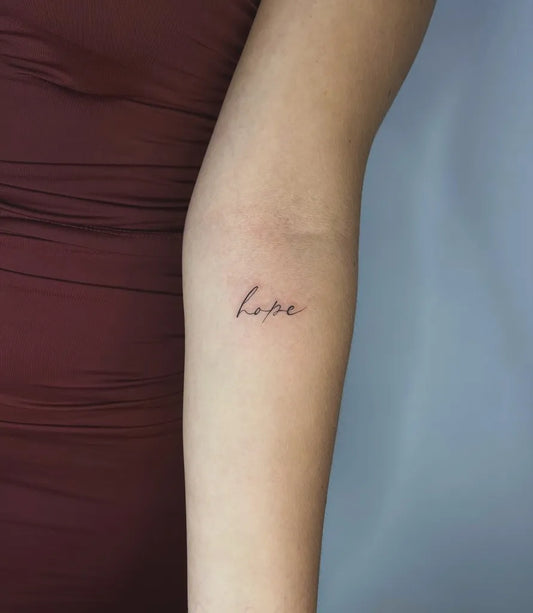 Tiny Minimalist Word on Women Forearm Tattoo by @rope_tattoo