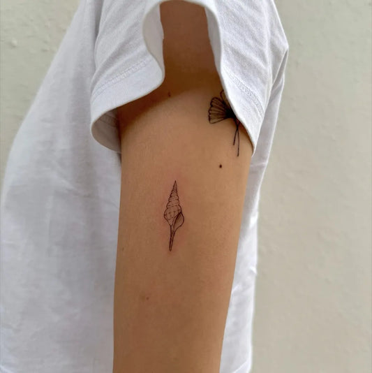 Tiny Minimalist butterfly arrowhead on Women Arm Tattoo by @letterbefore.n