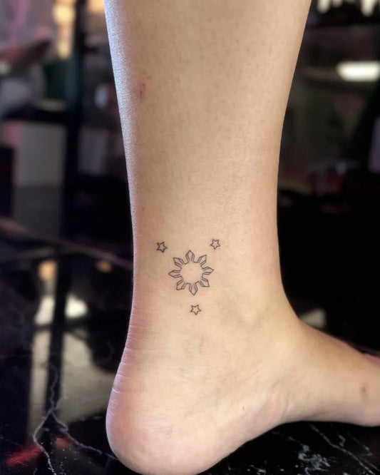 Tiny Minimalist floral sun with stars on Women ankle Tattoo by @yanninkstattoo