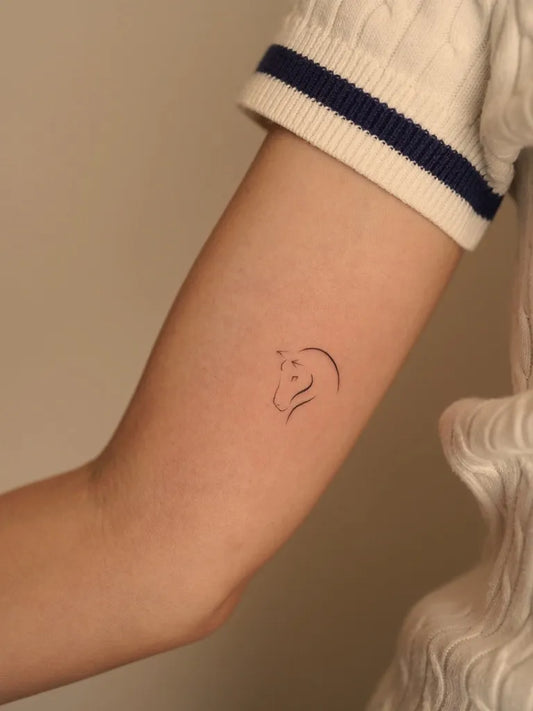 Tiny Minimalist horse silhouette on Women arm Tattoo by @j.tattooer_