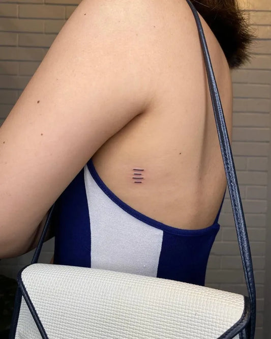 Tiny Minimalist three vertical lines on Women upper back Tattoo by @classikabarbers
