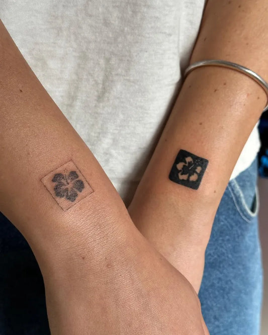 Tiny Negative Space Hibiscus Flower Tattoo on Women Wrist by @stinky.tatts