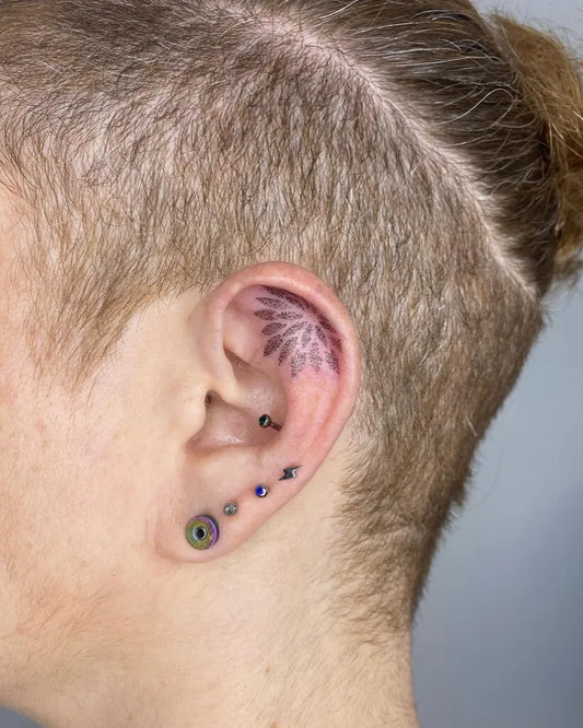 Tiny Neotraditional Flower on Men Ear Tattoo by @albamartintattoo