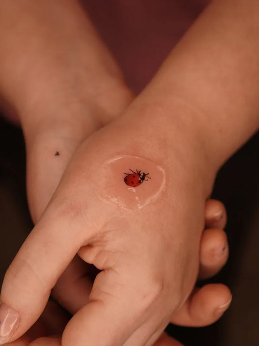 Tiny Realism Ladybug Tattoo on Women Hand by @eszter.tattoos