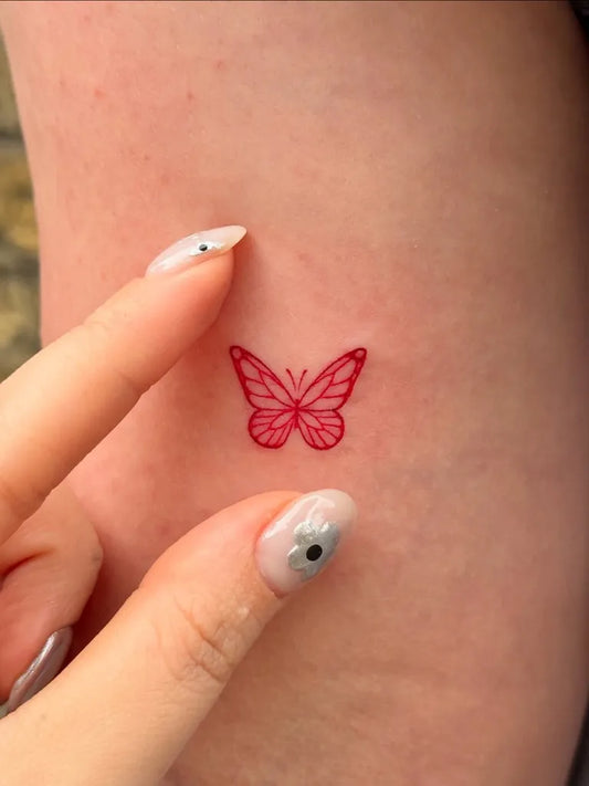 Tiny Red Butterfly Tattoo on Women Finger by @tattooer_jina