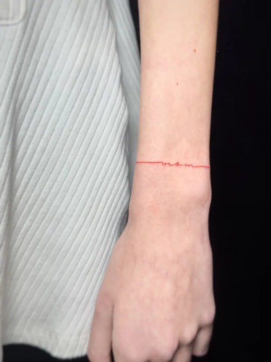 Tiny Red String Tattoo on Women Wrist by @marinatasseva