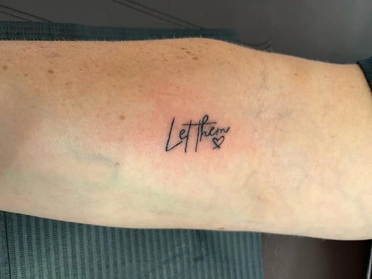 Tiny Script Let Them Heart on Women Arm Tattoo by @simplywright.tattoos