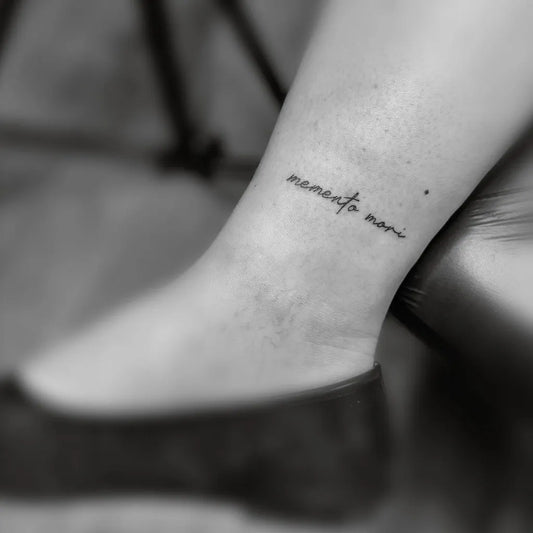 Tiny Script Memento Mori on Women Ankle Tattoo by @ausdruckstark.landau