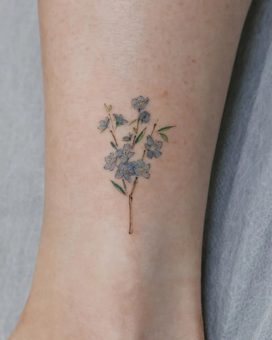 Tiny Watercolor Forget Me Not Flowers on Women Ankle Tattoo by @ihwatattoo