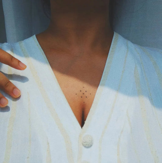 Tiny minimalist dots on Women Sternum Tattoo by @ana_ishh