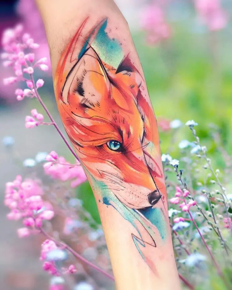 watercolor fox tattoo on forearm