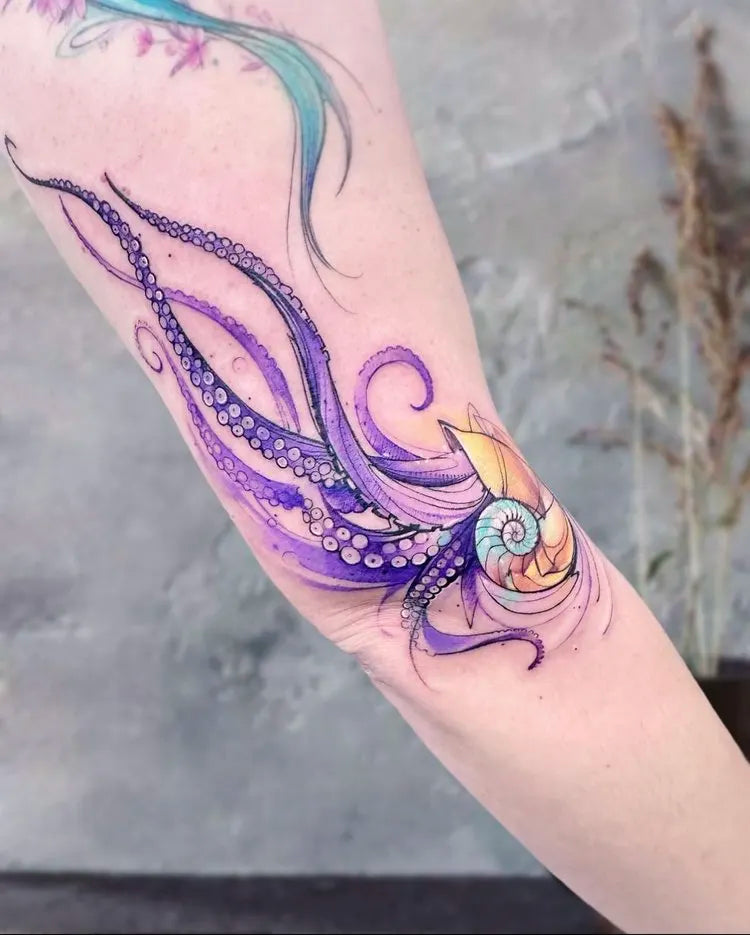 purple watercolor octopus tattoo on arm