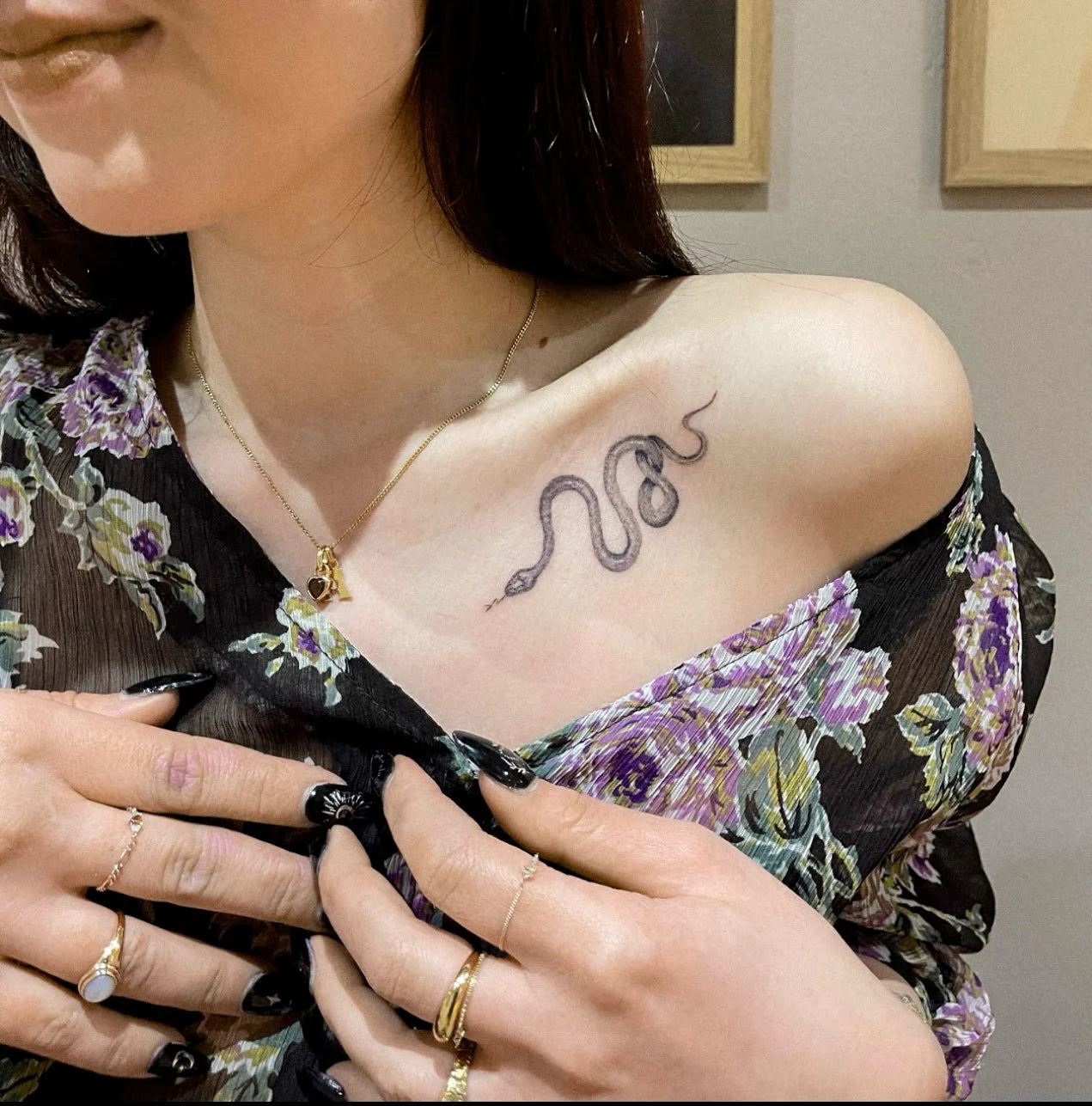 single needle snake tattoo on woman collarbone