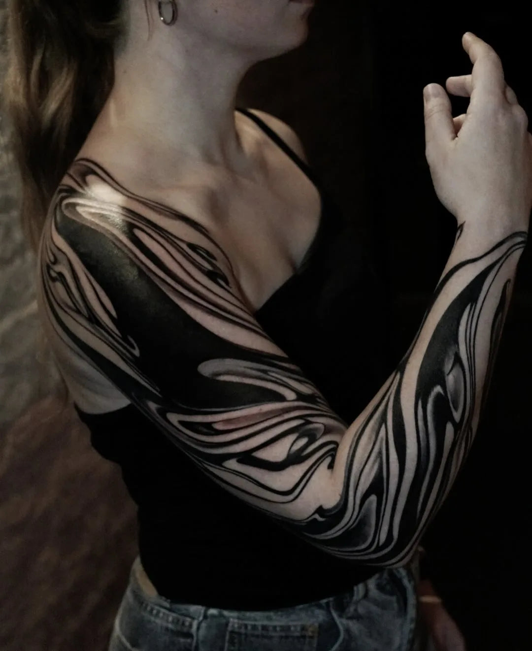 blackwork tattoo on woman full arm sleeve