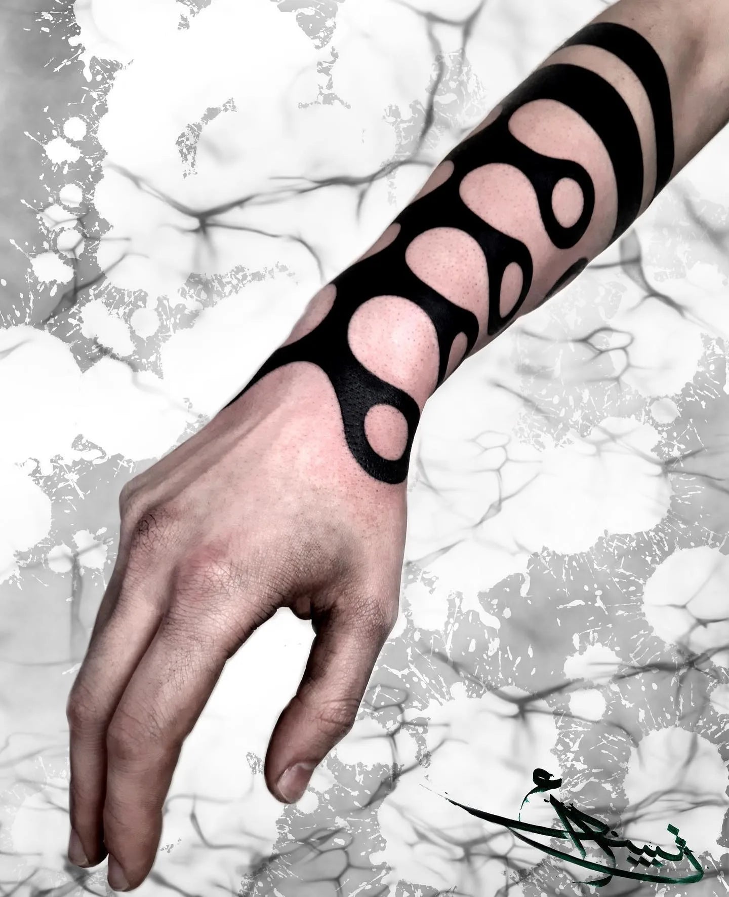 blackwork pattern tattoo on man forearm