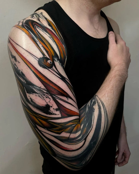 blackwork tattoo with red watercolor on man full arm sleeve