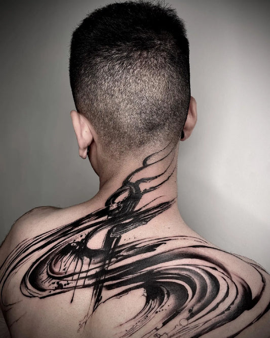 black watercolor brush stroke tattoo on man back and neck