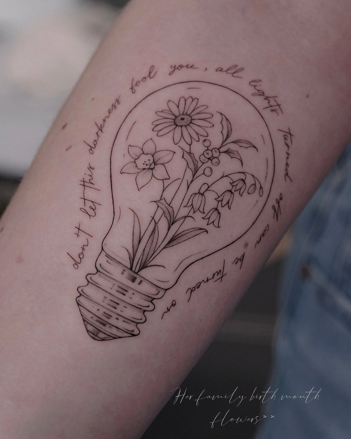 abstract fine line lightbulb tattoo with text and flowers