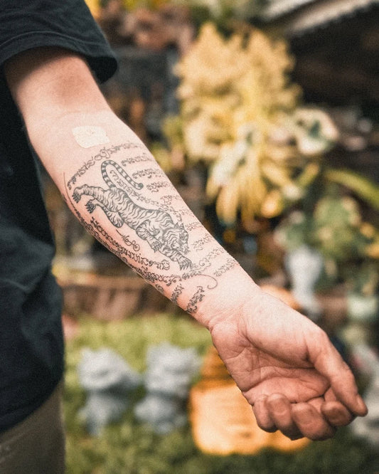 traditional Sak Yant tiger tattoo on man forearm