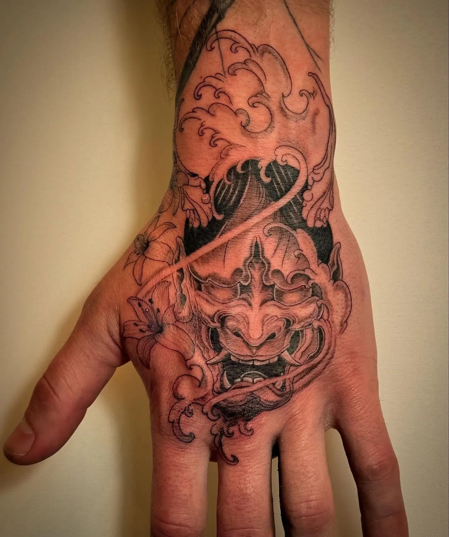 black and grey japanese hannya mask tattoo on hand