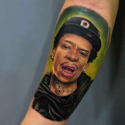 wiz khalifa portrait color realism tattoo on forearm