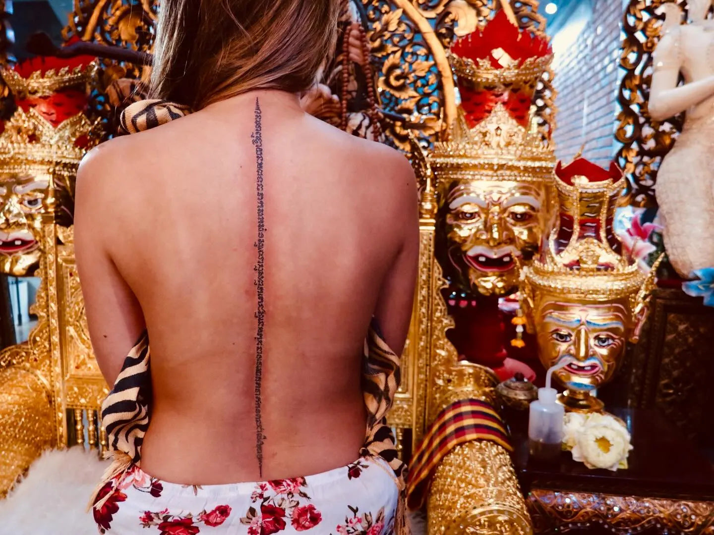 thai sak yant tattoo on woman spine back