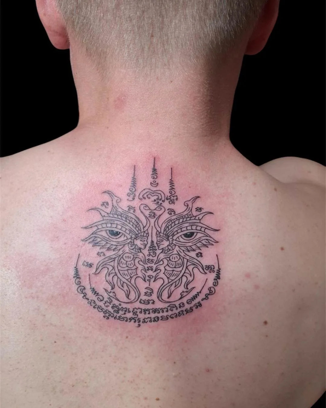 thai traditional sak yant tattoo on man back