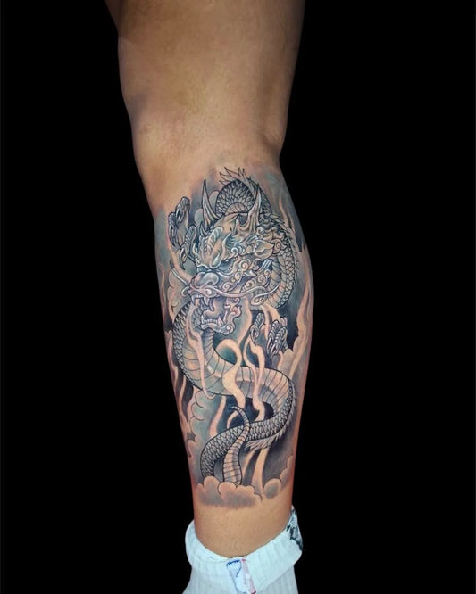 thai traditional dragon tattoo on man calf leg