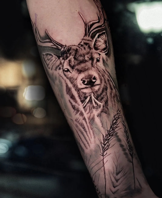 black and grey deer arm tattoo