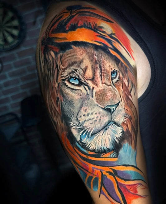 watercolor lion upper arm man tattoo
