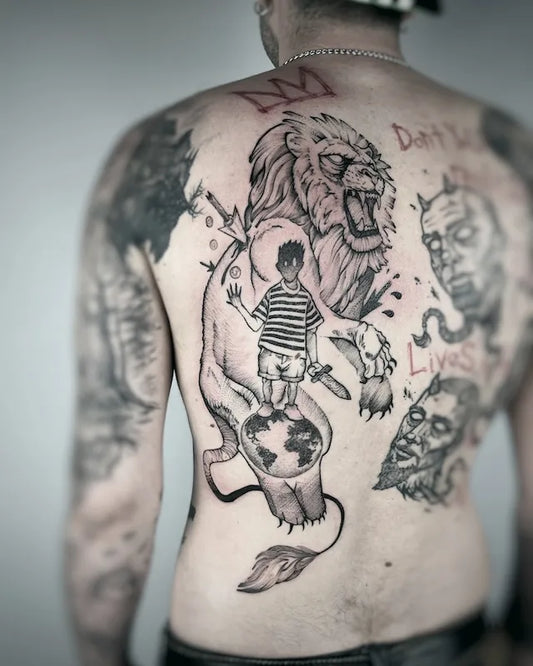 black and grey creepy boy and lion illustrative freehand tattoo on man back