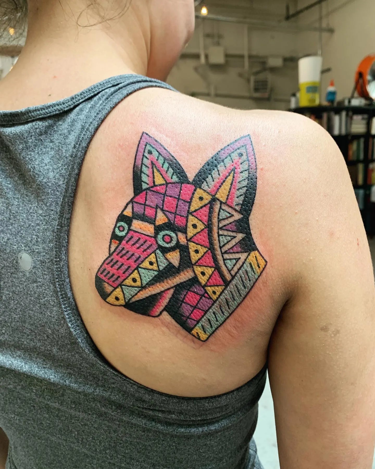 Colorful geometric fox tattoo on woman shoulder back