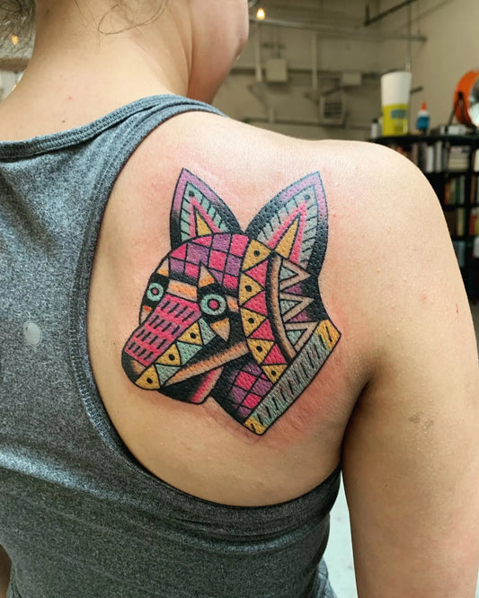 Colorful geometric fox tattoo on woman shoulder back