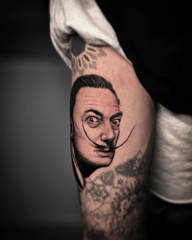 black and grey realism salvador dali portrait tattoo on arm
