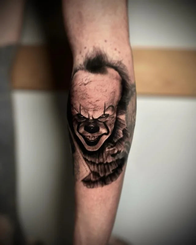 IT clown black and grey realism tattoo on leg