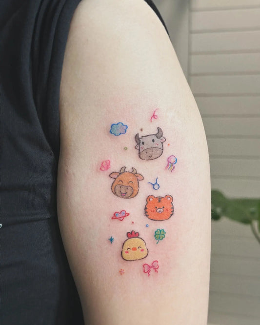 cute colorful animals minimalist tattoo on woman upper arm