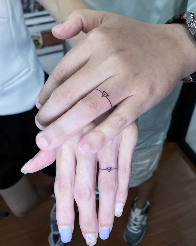 matching couple ring tattoo on fingers