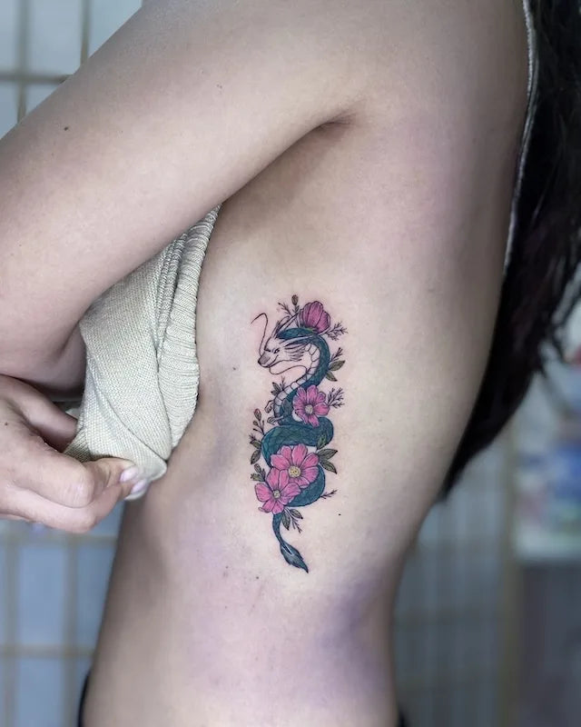 feminine dragon flower tattoo on woman rib