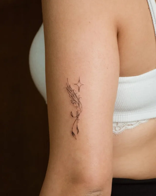 small minimalist fine line ornamental elegant tattoo on woman upper arm