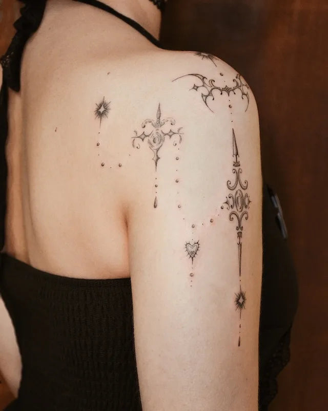 ornamental tattoos on woman shoulder and upper arm