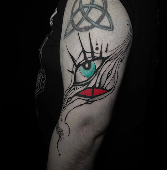 red and green eyeball horror abstract tattoo