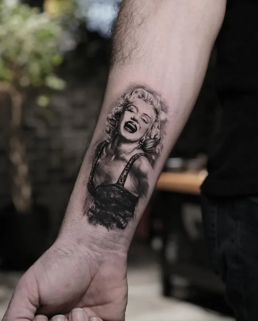 Marilyn Monroe black and grey portrait realism tattoo on man forearm wrist