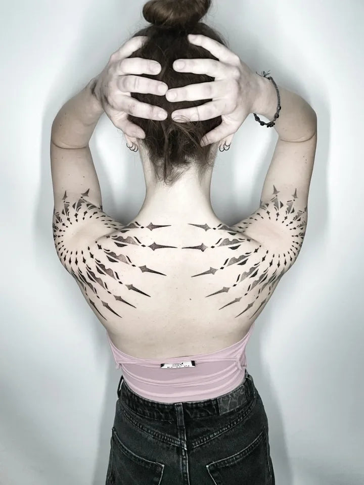 geometric tattoo on woman shoulder