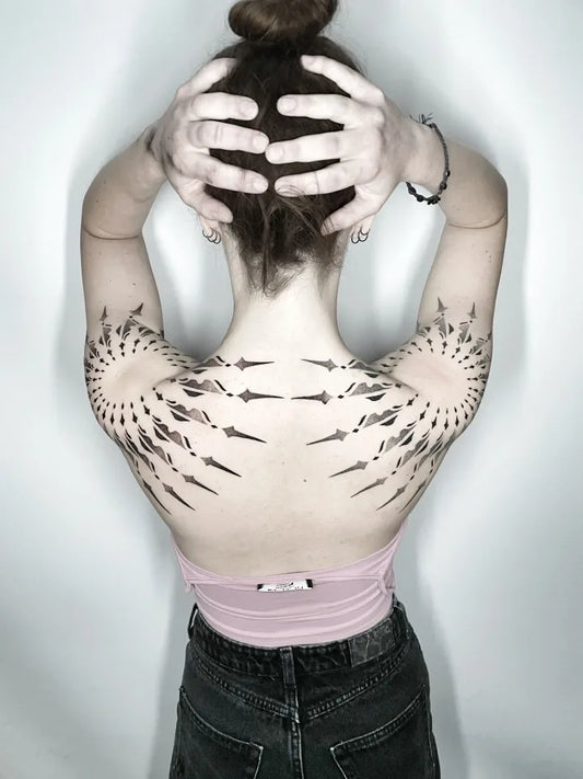 geometric tattoo on woman shoulder