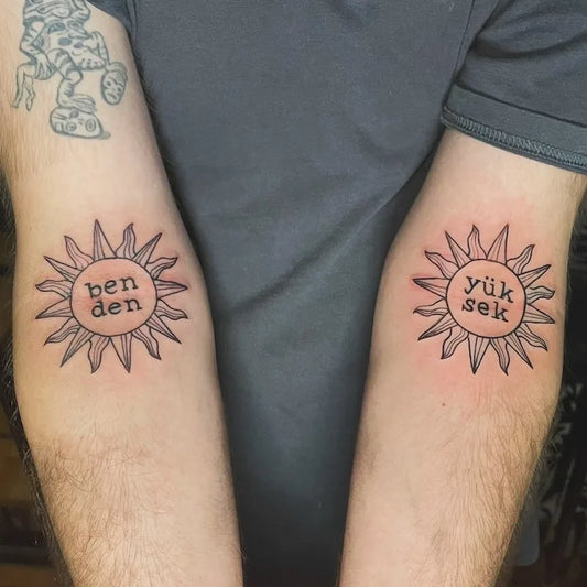matching tribal sun outline with names on arm