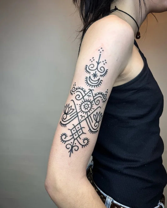 viking runes symbol black bold lines tattoo on woman upper arm sleeve