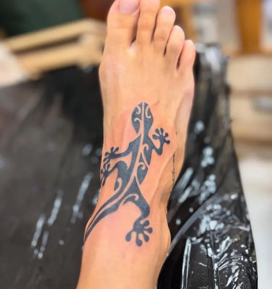 tribal lizard tattoo on foot
