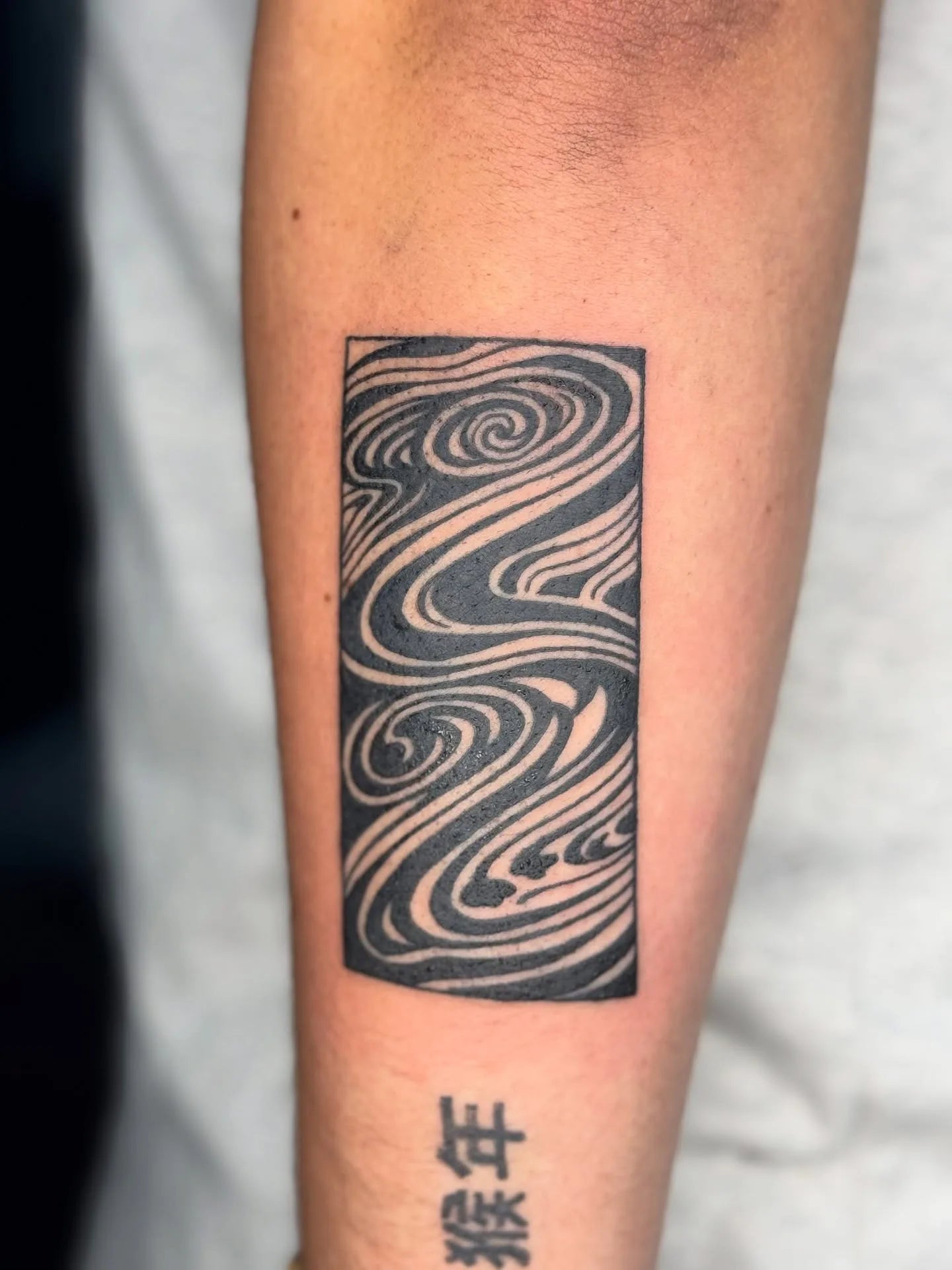 abstract blackwork lines rectangle tattoo on forearm